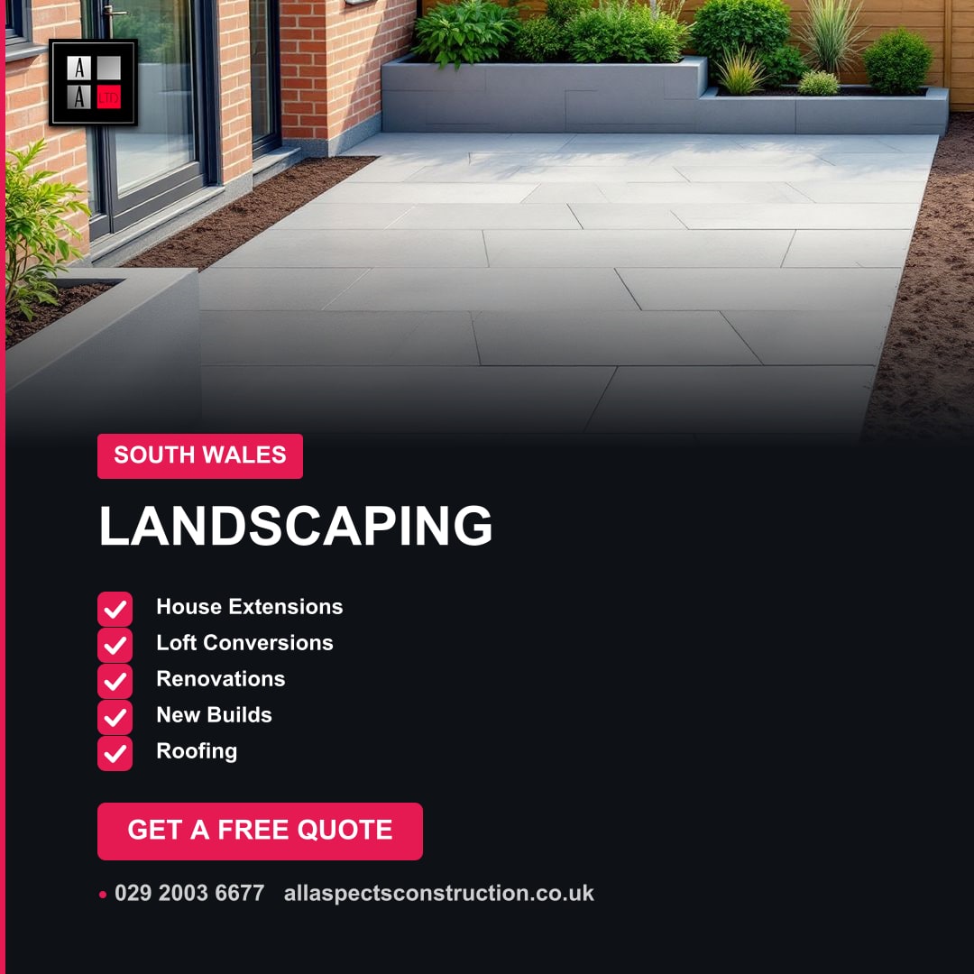 Modern garden patio with light grey paving slabs, raised planters, and green shrubs next to a brick house.