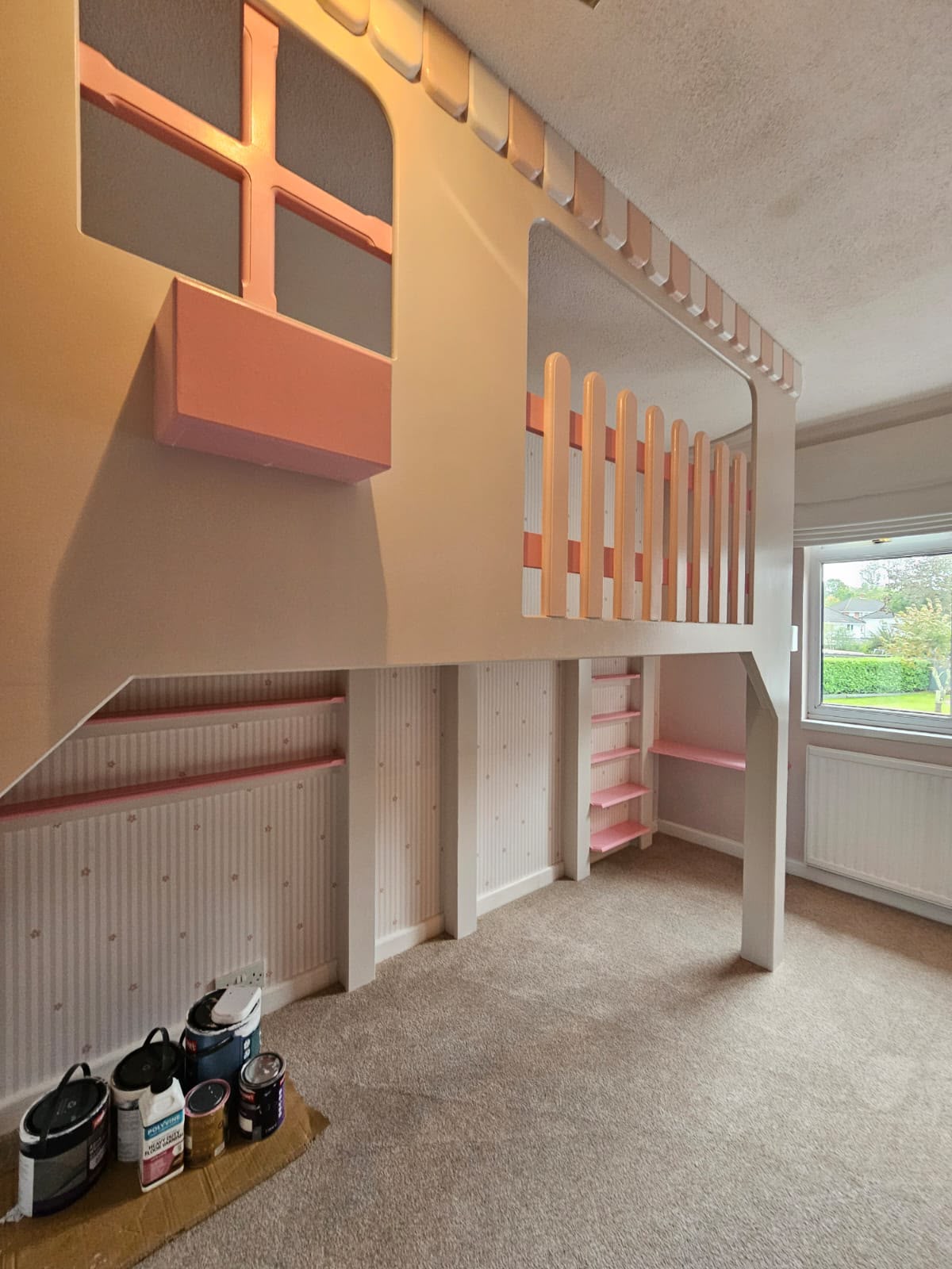 Playhouse loft bed with a pink window box and picket-fence rail, built for a girl's bedroom